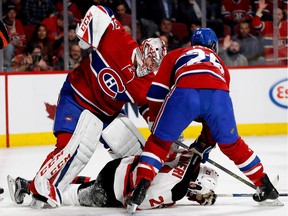Canadiens goalie Carey Price punches New Jersey Devils' Kyle Palmieri as Canadiens defenceman Jeff Petry drags Palmieri from the goal crease at the Bell Centre in Montreal on Thursday, Dec. 8, 2016.