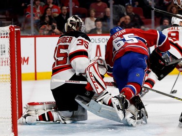 New Jersey Devils goalie Cory Schneider extends his leg and trips Montreal Canadiens centre Andrew Shaw during NHL action at the Bell centre in Montreal on Thursday December 8, 2016.