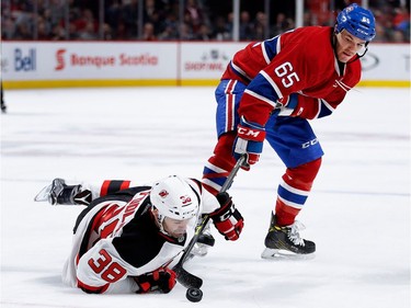 New Jersey Devils left wing Vernon Fiddler is knocked to the ice as Montreal Canadiens centre Andrew Shaw takes the puck from him during NHL action at the Bell Centre in Montreal on Thursday December 8, 2016.