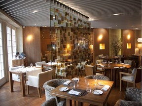 Glass dividers with its coloured squares in the dining area at Maison Boulud in Montreal Friday June 8, 2012.  (Vincenzo D'Alto / THE GAZETTE)
online caption:
Clear glass dividers with pale coloured squares define different zones within Maison Boulud at the Ritz-Carlton Montreal. The space and its furnishings were designed by the Japanese firm Super Potato but the tables and chairs were manufactured in Quebec, as was some of the  lighting. Elément Bois in Lachute made the tables; the chairs were made by Les Ameublements Renaissance in Laval. The floors and tables are cherry wood, and the cherry is repeated in wall panels.