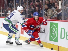 Montreal Canadiens' Alex Galchenyuk slips past Vancouver Canucks Alexander Edler during first period of National Hockey League game in Montreal Wednesday November 2, 2016.