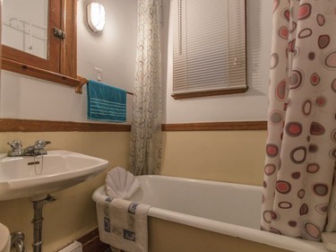 A view of the small bathroom and bathtub at the apartment of Marie-Thérèse Nichele in Plateau-Mont-Royal.