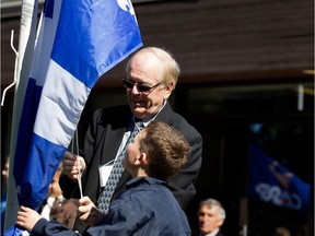 MONTREAL, QUE.: OCTOBER 1, 2015-- Beaconsfield Mayor Georges Bourelle gets help from a Christmas Park School student to raise the Quebec flag during a senior citizen appreciation event in Montreal on Thursday October 1, 2015.  (Allen McInnis / MONTREAL GAZETTE)
