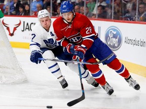 Toronto Maple Leafs centre Leo Komarov, left, tries to slow down Montreal Canadiens defenceman Nathan Beaulieu during preseason NHL action at the Bell centre in Montreal on Thursday October 6, 2016.