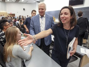 In 2016, Parti Québécois leadership candidates Jean-Francois Lisee and Martine Ouellet shake hands with audience members prior to a debate at Université de Montréal.