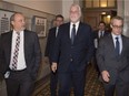 Quebec Premier Philippe Couillard, flanked by his cabinet's chief of staff Jean-Louis Dufresne, left, and press attaché Charles Robert, walk to question period, Thursday, October 27, 2016 at the legislature in Quebec City.