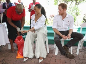 Prince Harry watches as singer Rihanna gets her blood sample taken for an HIV test in order to promote more widespread testing for the public at the Man Aware event held by the Barbados National HIV/AIDS Commission on Dec. 1, 2016, in Bridgetown, Barbados.