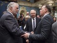 Quebec Premier Philippe Couillard, left, shakes hand with Coalition Avenir Quebec Leader Francois Legault as Parti Quebecois Leader Jean-Francois Lisee, centre looks on, after they gave their season's greetings to Quebecers from the National Assembly, in Quebec City on Friday, December 9, 2016. A Léger Marketing poll for January suggests the Liberals remain slightly ahead of the PQ in popularity.