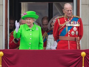 Queen Elizabeth II and Prince Philip are seen on the balcony of Buckingham Palace  watching a fly-past of aircrafts by the Royal Air Force on June 11, 2016, during the annual Queen's 90th birthday celebration.