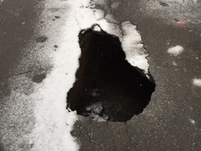 A sinkhole forces one block of Jeanne-Mance St. to be closed in downtown Montreal Dec. 5, 2016.