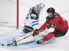Canada's Taylor Raddysh (16) scores against Finland's goaltender Veini Vehvilainen during first period pre-tournament exhibition hockey action in Montreal, Monday, Dec. 19, 2016. IIHF World Junior Championship starts on Monday, Dec. 26, 2016.