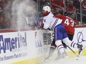 Washington Capitals' Tom Wilson escapes a check from Canadiens defenceman Alexei Emelin of Russia during the second period of an NHL hockey game in Washington on Saturday, Dec. 17, 2016.