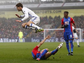 Chelsea's Spanish defender Marcos Alonso (left) hurdles a challenge from Crystal Palace's French midfielder Yohan Cabaye (centre) during the English Premier League football match between Crystal Palace and Chelsea at Selhurst Park in south London on Dec. 17, 2016.