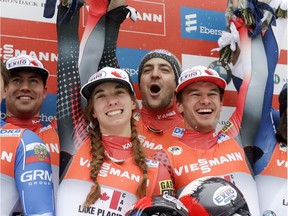 Team Canada members Tristan Walker, Kimberley McRae, Samuel Edney and Justin Snith celebrate after winning the luge team relay World Cup race on Saturday, Dec. 3, 2016, in Lake Placid, N.Y.