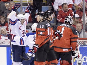 United States forward Colin White (18), left, celebrates after scoring against Canada during first period IIHF World Junior Championship hockey action in Toronto on Saturday, Dec. 31, 2016.