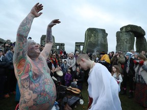 Druids, pagans and revellers gather in the centre of Stonehenge for a winter solstice ceremony at the ancient neolithic monument of Stonehenge Dec. 21, 2016.