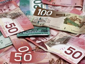 Local Input~  Pile of Canadian dollars,  100, 50 and 20 dollar bills. Credit: fotolia

0204 biz wire loonie