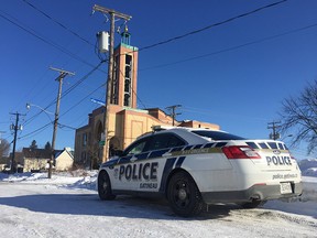 A single police officer in a patrol car sits outside the mosque in Gatineau Quebec following the killings at a mosque in Quebec City on Sunday. Photo by Wayne Cuddington / Postmedia