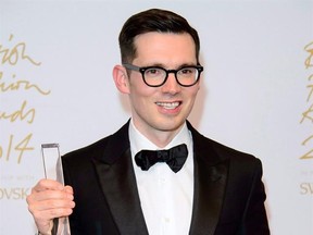 Designer Erdem Moralioglu poses for photographers with his Best Womanswear award at The British Fashion Awards 2014, in London, Monday, Dec. 1, 2014. Award-winning designer Erdem Moralioglu could soon be adding to his accolades at the upcoming Canadian Arts and Fashion Awards. THE CANADIAN PRESS/AP, Jonathan Short, Invision