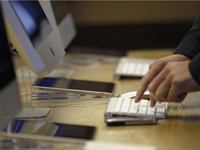 A person keys something into a computer.