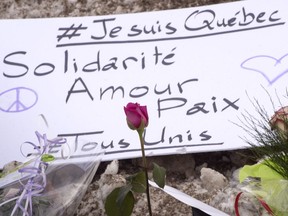 A sign is seen near a mosque in Quebec City Jan. 31, 2017, where a shooting killed six Muslims Sunday.