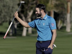 Adam Hadwin celebrates on the 18th hole after shooting a 59 to take the third round lead in the CareerBuilder Challenge golf tournament at La Quinta Country Club Saturday, Jan. 21, 2017, in La Quinta, Calif.