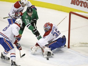 Canadiens goalie Al Montoya stops the puck while Jeff Petry (26) and Nathan Beaulieu battle against Stars winger Brett Ritchie during the second period Wednesday night in Dallas.