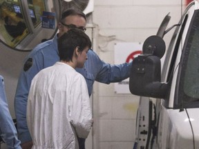 Alexandre Bissonnette, the accused in the Quebec City mosque shooting spree, is escorted to a van after appearing in court in January 2017.