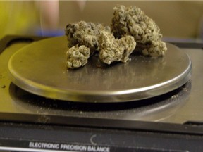 File photo of marijuana being weighed on a scale at a medical dispensary in Los Angeles.