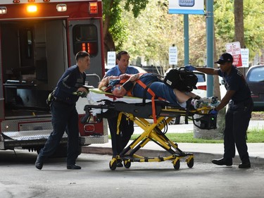 An injured woman is taken into Broward Health Trauma Center in Fort Lauderdale, Fla., after a shooting at the Fort Lauderdale-Hollywood International Airport on Friday, Jan. 6, 2017. Authorities say a lone shooter opened fire at the airport Friday afternoon, killing "multiple" people before he was taken into custody. (Taimy Alvarez/South Florida Sun-Sentinel via AP) ORG XMIT: FLLAU202