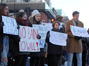 Protesters in Kingston, Ont., target exclusionary policies of U.S. President Donald on Sunday. A demonstration is being organized in front of the U.S. consulate in downtown Montreal on Monday.