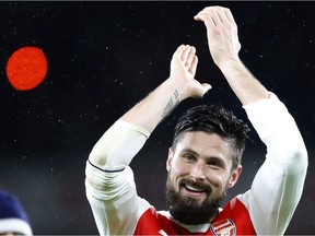 Arsenal's Olivier Giroud applauds supporters after his team won the English Premier League soccer match between Arsenal and Crystal Palace at the Emirates stadium in London, Sunday, Jan. 1, 2017.