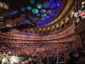 Patriotic revellers wave flags at the Royal Albert Hall in west London, on September 12, 2009, during the last night of the Proms. The final evening of the Proms season is traditionally connected with flamboyant displays of patriotism with the many Union Flags mixing with a range of other country's colours. AFP PHOTO/Leon Neal (Photo credit should read Leon Neal/AFP/Getty Images)