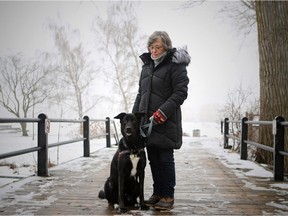 Buddy the Great Dane/Black Labrador mix sits  with owner Donna Teatro near the Fur Trade national historic site in the heart of Old Lachine.