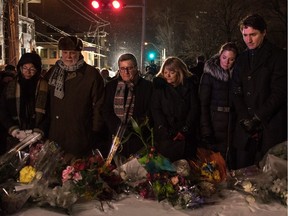 Quebec Premier Philippe Couillard and his wife, Quebec City Mayor Regis Labeaume and his wife, Sophie Gregoire-Trudeau and Canadian Prime Minister Justin Trudeau lay flowers near the Islamic Cultural Centre in Quebec City Jan. 30, 2017, a day after a gunman killed six people.