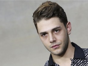 Canadian director Xavier Dolan poses during a photocall prior to the Chanel 2015 Spring/Summer ready-to-wear collection fashion show, on September 30, 2014 in Paris.
