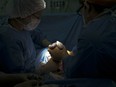 FILE: Doctors carry out a caesarean section in a maternity center in Caracas.