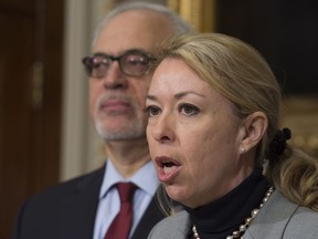 Quebec Labour Minister Dominique Vien announces an increase in the minimum wage, as Quebec Finance Minister Carlos Leitao, left, looks on, Thursday, January 19, 2017 at the legislature in Quebec City.