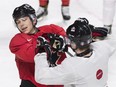 Team Canada captain Dylan Strome, left, jokes around with teammate Taylor Raddysh (16) during practice ahead of their quarter-final round match against the Czech Republic at the IIHF World Junior hockey Championship in Montreal, Sunday, Jan. 1, 2017.