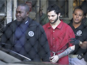 Esteban Santiago, center, is led from the Broward County jail for an arraignment in federal court, Monday, Jan. 30, 2017, in Fort Lauderdale, Fla. Santiago is charged in a 22-count federal indictment in the Jan. 6 shooting at the Fort Lauderdale-Hollywood International Airport.