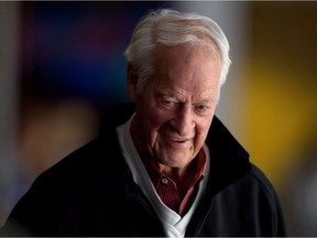 Hockey great Gordie Howe watches the Vancouver Canucks and San Jose Sharks play during an NHL hockey game in Vancouver, B.C., on Nov. 14, 2013.