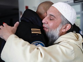 Imam Syed Fida Bukhari welcomes Montreal Police Station 7 Commander Miguel Alston to the Islamic Centre of Quebec in St-Laurent Jan. 30, 2017, the day after a terrorist attack on a mosque in Quebec City.