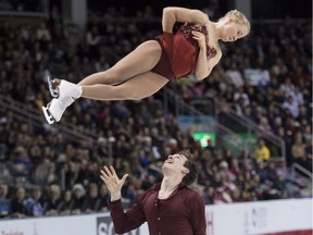 Julianne Seguin is thrown by her partner Charlie Bilodeau as they perform their free program to win the bronze medal in the pairs competition at the Canadian Figure Skating Championships on Jan. 24, 2015, in Kingston, Ont.