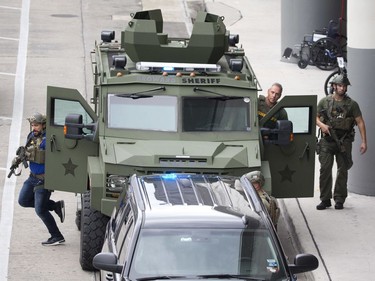 Law enforcement personnel arrive in an armored car outside Fort Lauderdale–Hollywood International Airport, Friday, Jan. 6, 2017, in Fort Lauderdale, Fla. A gunman opened fire in the baggage claim area at the airport Friday, killing several people and wounding other before being taken into custody in an attack that sent panicked passengers running out of the terminal and onto the tarmac, authorities said.