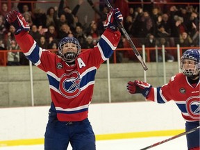 Les Canadiennes forward Ann-Sophie Bettez, pictured with arms raised, celebrates a goal during the Canadian Women's Hockey League game at the Civic Centre in Dollard-des-Ormeaux, Jan. 15, 2017. Bettez scored twice in the game against the Calgary Inferno. Les Canadiennes won 4-1. Photo credit: Louis-Charles Dumasi/CWHL
