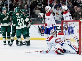 Canadiens' Alexander Radulov, Carey Price and Jeff Petry #look on in disgust as Minnesota Wild players celebrate a goal by Nino Niederreiter during the second period Thursday night at the at Xcel Energy Center in St Paul, Minn.