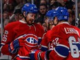 Canadiens defenceman Jeff Petry, left, congratulates teammate Tomas Plekanec, centre, on Plekanec's goal against the Washington Capitals during the third period Monday. But Petry allowed Evgeny Kuznetsov to skate around him and score less than a minute later. "It was unacceptable for me to let that happen," he said.