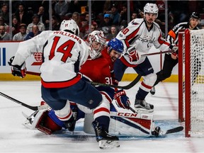 Montreal Canadiens goalie Carey Price (31) can't locate the loose puck in the feet of Washington Capitals right wing Justin Williams (14) with teammate Montreal Canadiens defenceman Shea Weber (6) looking on during 2nd period NHL action at the Bell Centre in Montreal, on Monday, January 9, 2017.