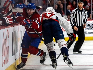 Montreal Canadiens right wing Sven Andrighetto (42) is caught between the boards by Washington Capitals defenceman Karl Alzner (27) during 1st period NHL action at the Bell Centre in Montreal, on Monday, January 9, 2017.
