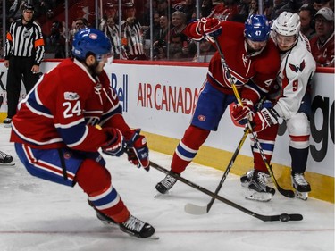 Montreal Canadiens right wing Alexander Radulov (47) checks Washington Capitals defenceman Dmitry Orlov (9) against the boards as Montreal Canadiens left wing Phillip Danault (24) takes the loose puck during 2nd period NHL action at the Bell Centre in Montreal, on Monday, January 9, 2017.
